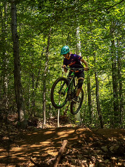 Moutain biker jumping a feature in Vermont