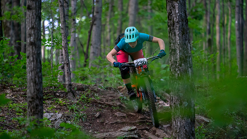 Mountain biker racing in the woods